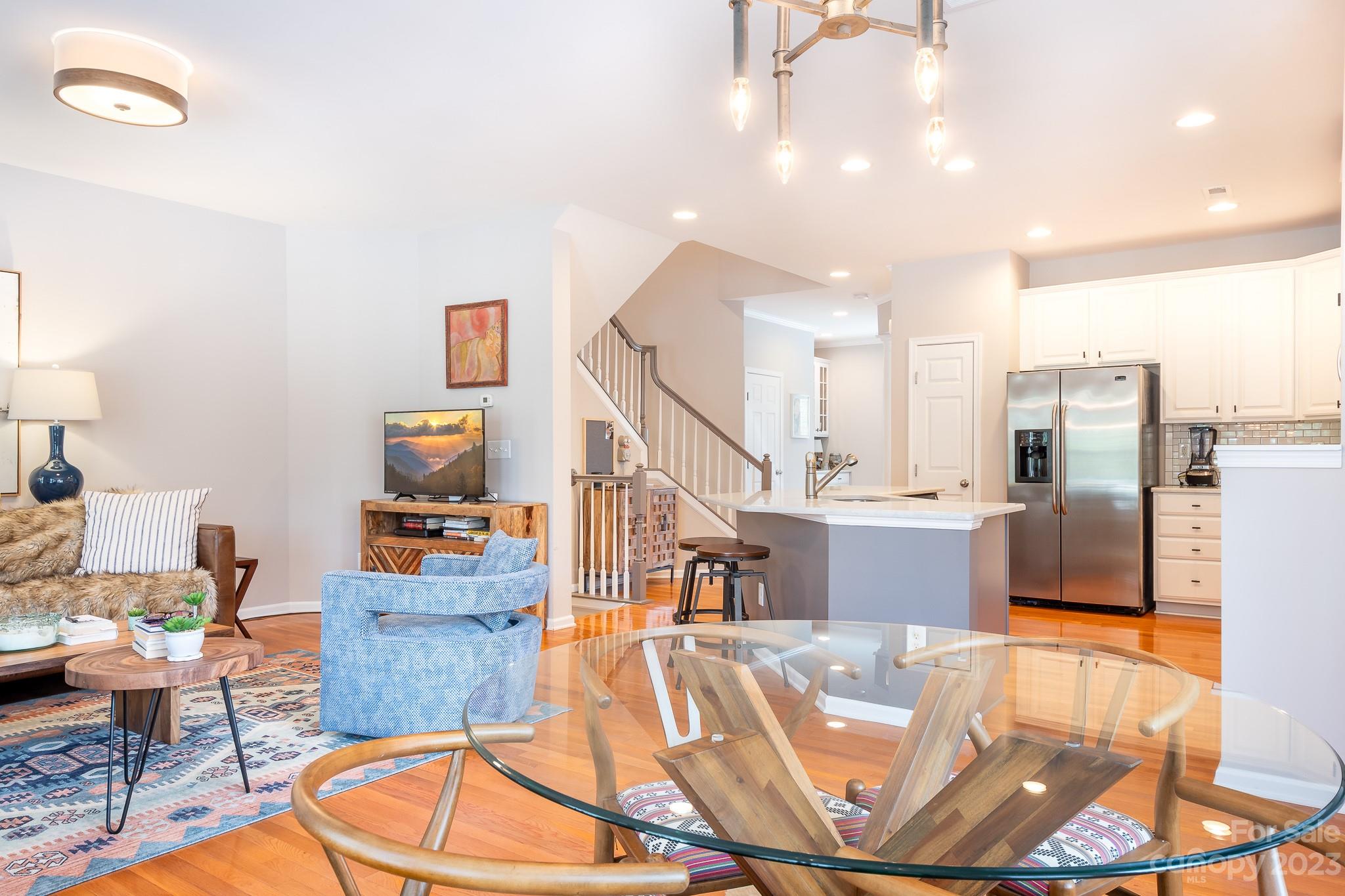 725 Naramore Street Davidson, NC 28036 - Photo 11 of 27 a living room with dining room and wooden floor