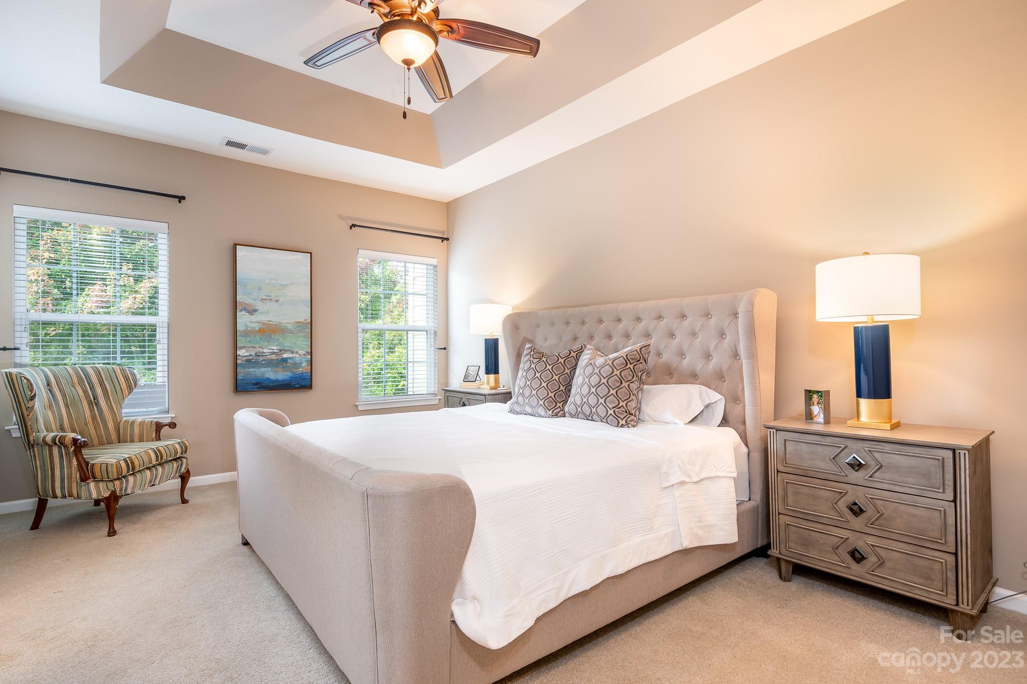 725 Naramore Street Davidson, NC 28036 - Photo 14 of 27 a bedroom with a bed a chandelier and a window