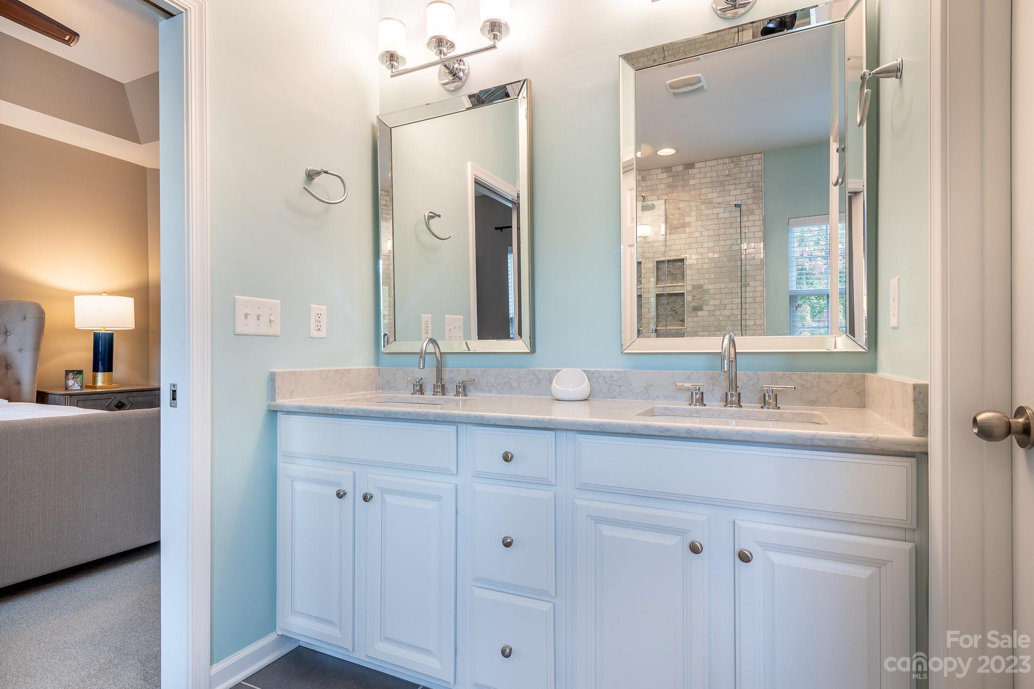 725 Naramore Street Davidson, NC 28036 - Photo 15 of 27 a bathroom with double sink and a mirror
