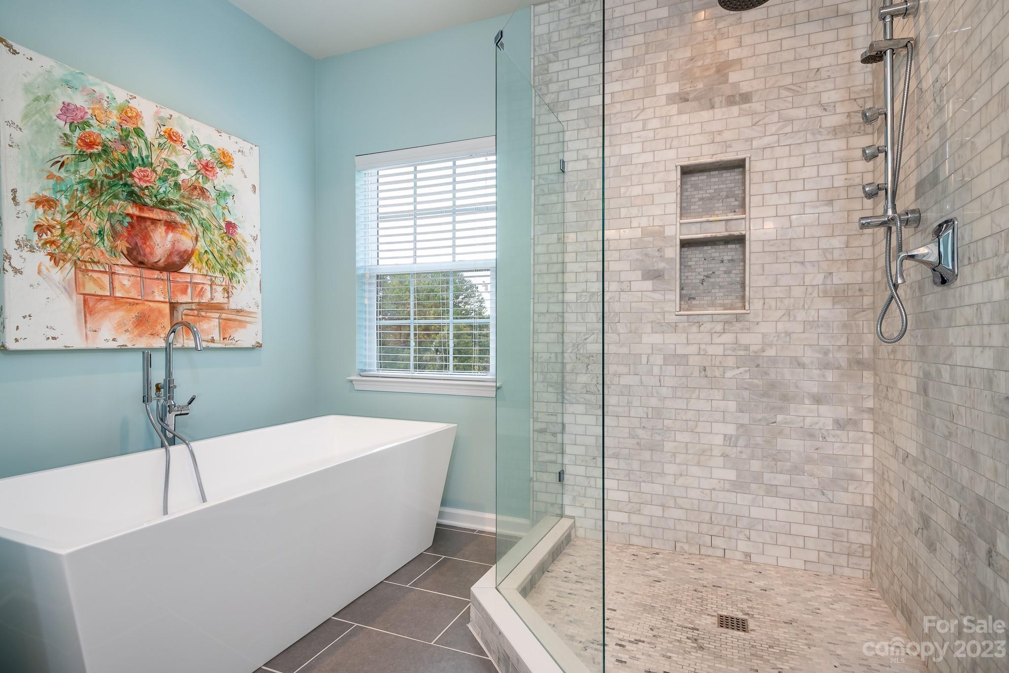 725 Naramore Street Davidson, NC 28036 - Photo 16 of 27 a bathroom with a bathtub and shower