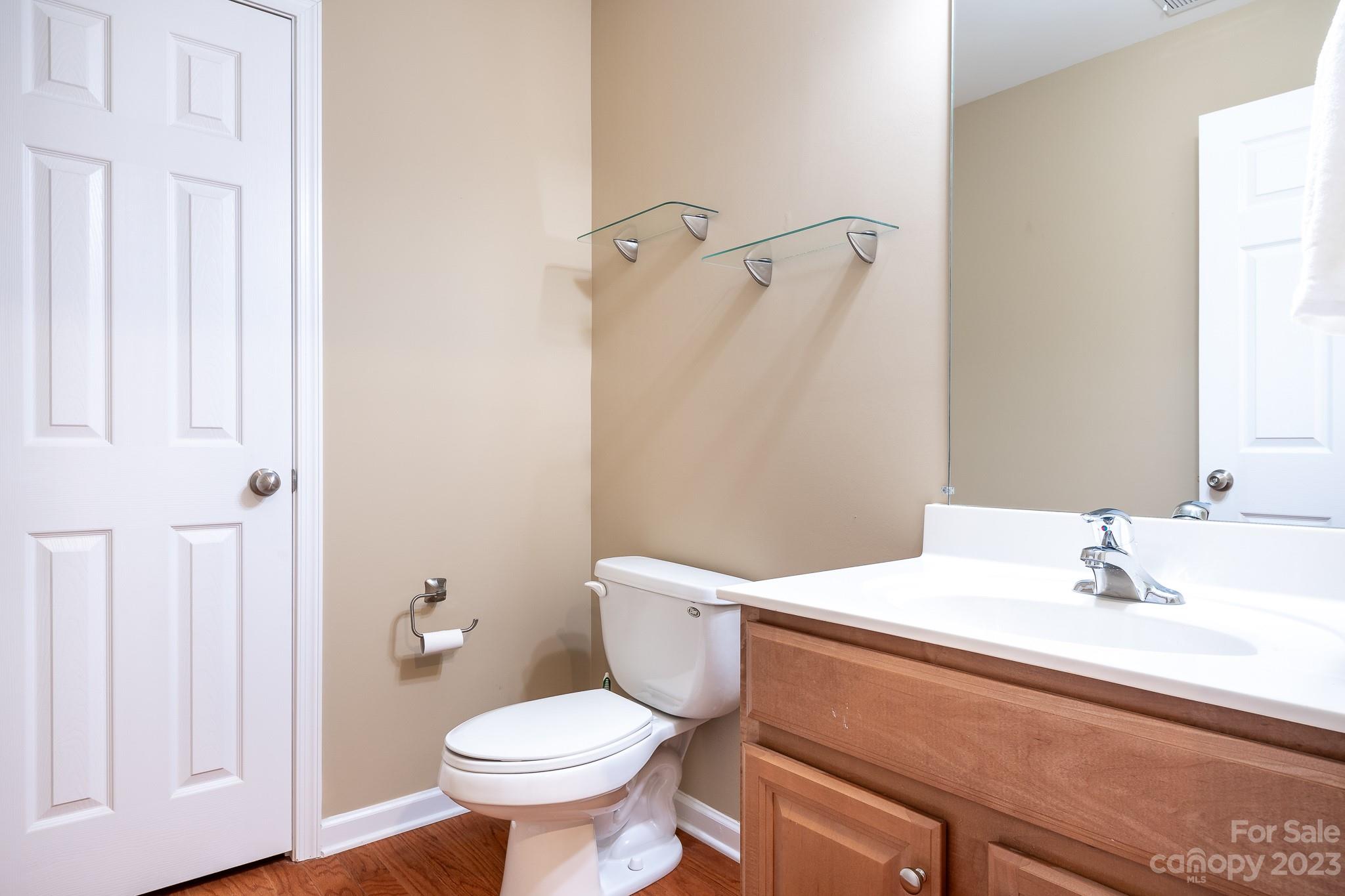 725 Naramore Street Davidson, NC 28036 - Photo 22 of 27 a bathroom with a sink toilet and a mirror