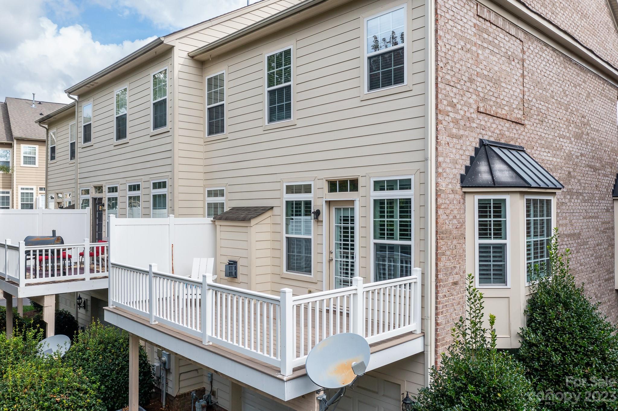 725 Naramore Street Davidson, NC 28036 - Photo 23 of 27 a view of a house with wooden deck and furniture