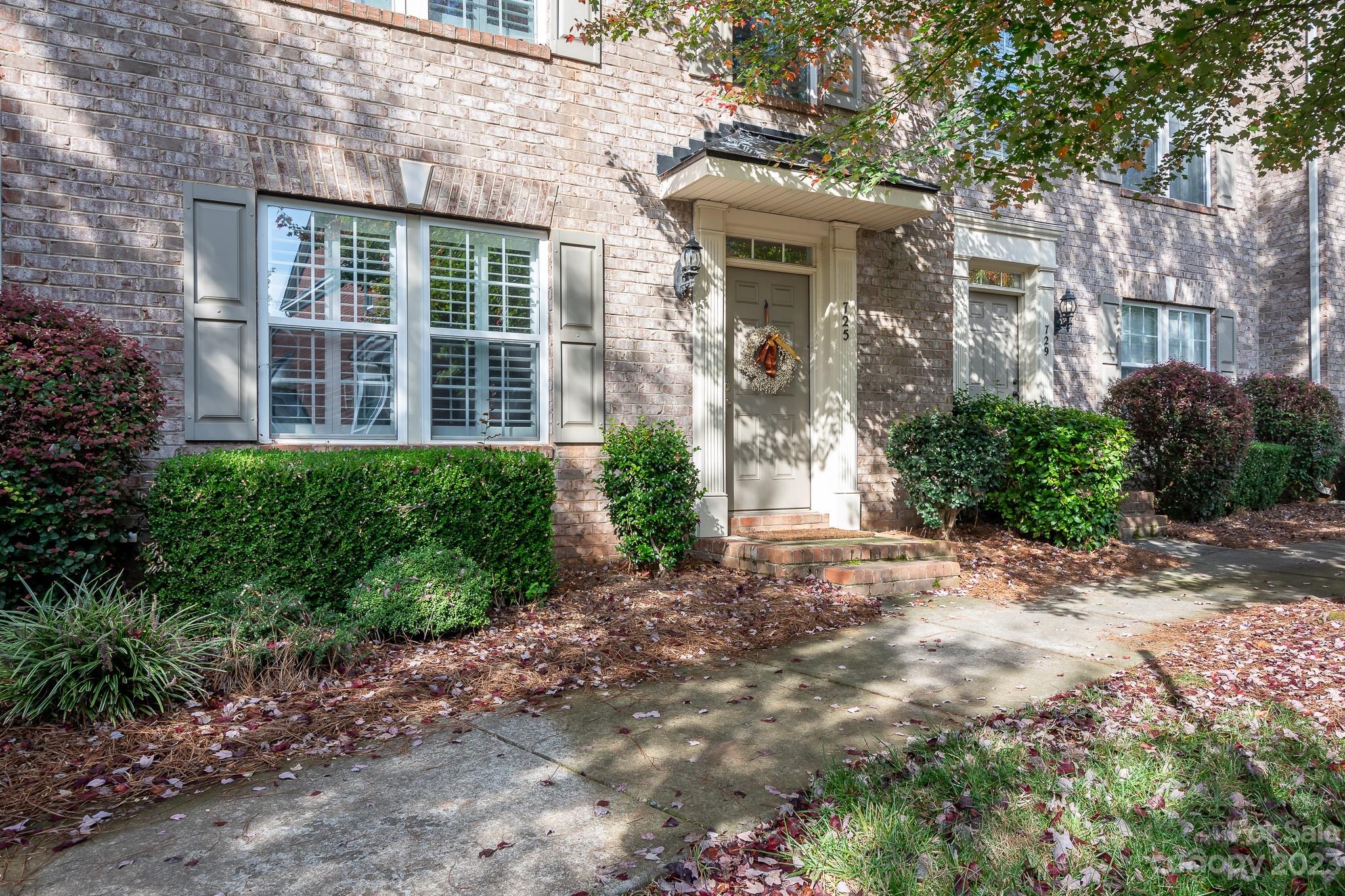 725 Naramore Street Davidson, NC 28036 - Photo 3 of 27 a view of a brick building next to a road