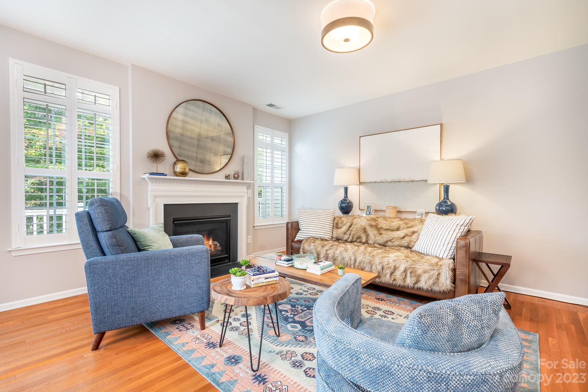 725 Naramore Street Davidson, NC 28036 - Photo 8 of 27 a living room with furniture fireplace and a large window