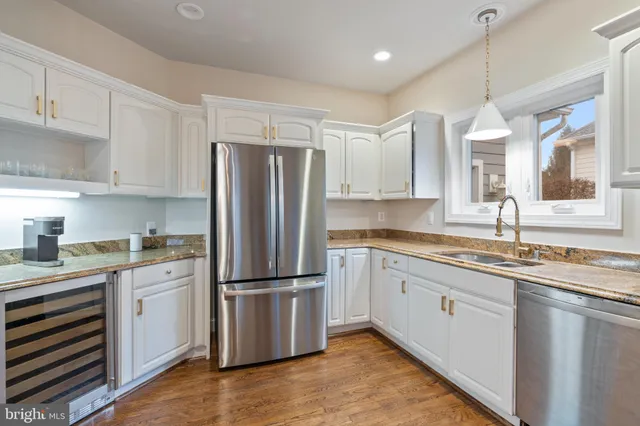 a bathroom with a granite countertop sink a large mirror and vanity