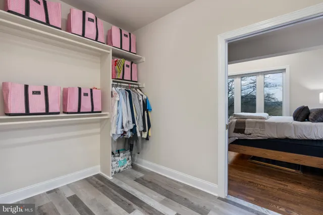 a view of walk in closet with clothes
