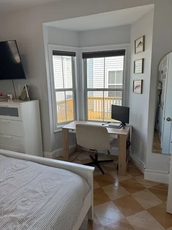 a bedroom with a bed and a desk