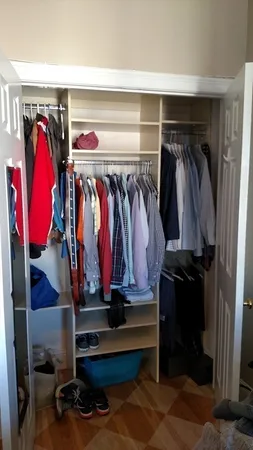a view of walk in closet with clothes and shoes