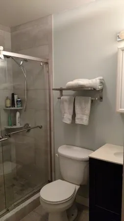 a white toilet sitting next to a bathroom sink