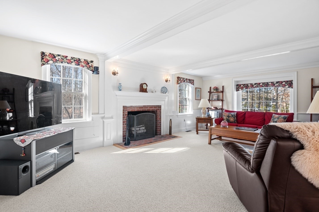 17 Coleman Road Newbury, MA 01922 - Photo 3 of 42 a living room with furniture a flat screen tv and a fireplace
