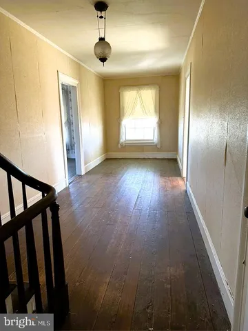 a living room with a fireplace furniture a rug and a window