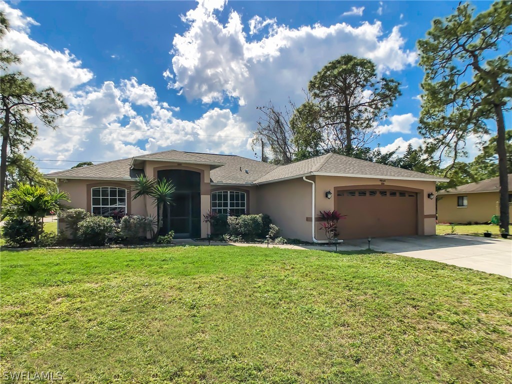 9068 Morris Road Fort Myers, FL 33967 - Photo 1 of 29 a view of a house with a yard and pathway