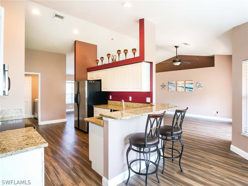 9068 Morris Road Fort Myers, FL 33967 - Photo 11 of 29 a view of a dining room with furniture and wooden floor
