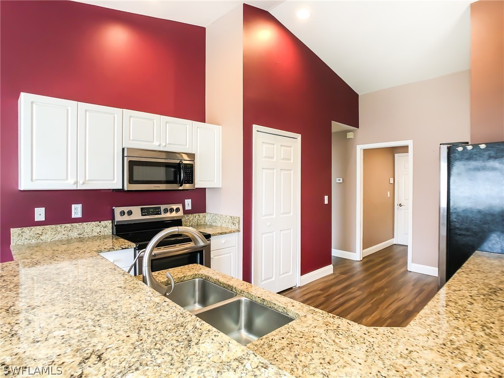 9068 Morris Road Fort Myers, FL 33967 - Photo 13 of 29 a bedroom with a bed and a flat screen tv