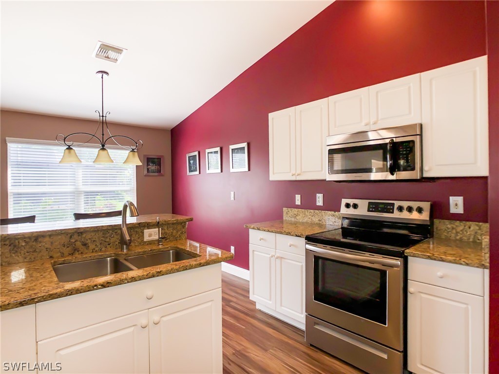 9068 Morris Road Fort Myers, FL 33967 - Photo 15 of 29 a kitchen with granite countertop a sink stainless steel appliances and cabinets
