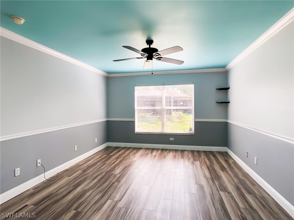 9068 Morris Road Fort Myers, FL 33967 - Photo 16 of 29 wooden floor in an empty room with a window