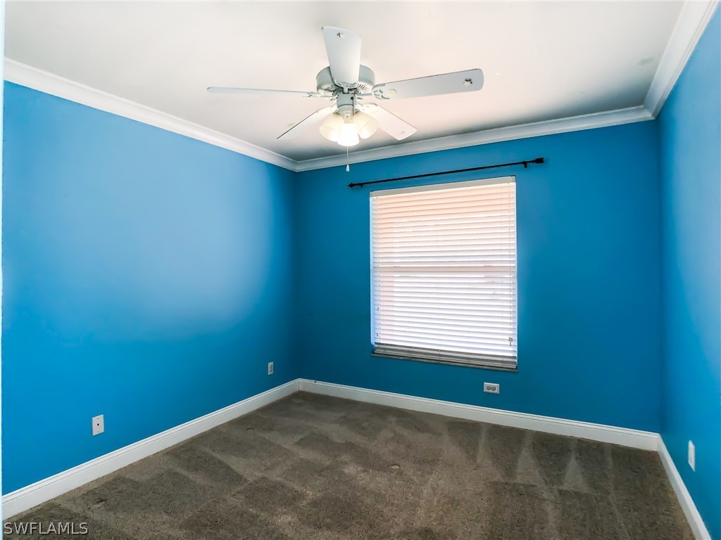 9068 Morris Road Fort Myers, FL 33967 - Photo 20 of 29 an empty room with a window and a fan