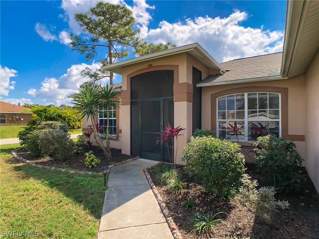 9068 Morris Road Fort Myers, FL 33967 - Photo 2 of 29 a front view of a house with garden