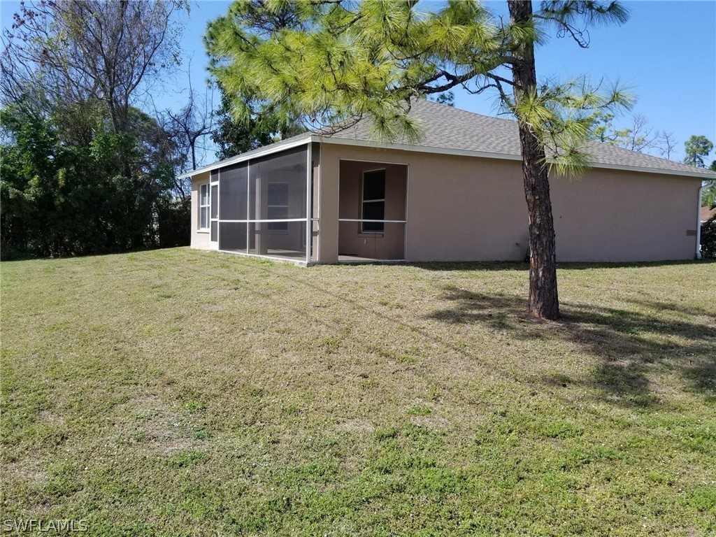 9068 Morris Road Fort Myers, FL 33967 - Photo 27 of 29 a house with trees in front of it