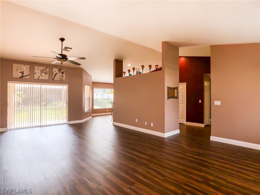 9068 Morris Road Fort Myers, FL 33967 - Photo 3 of 29 a view of a livingroom with wooden floor and a ceiling fan