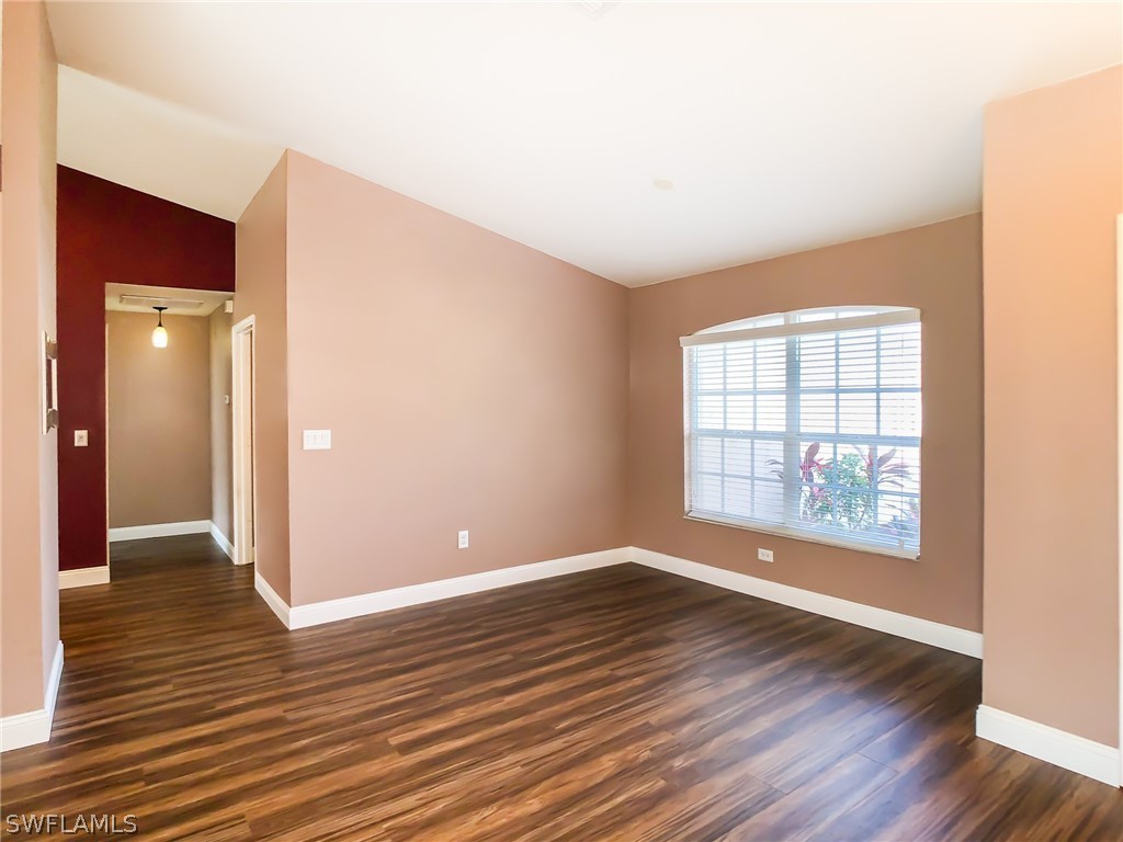 9068 Morris Road Fort Myers, FL 33967 - Photo 4 of 29 an empty room with wooden floor and windows