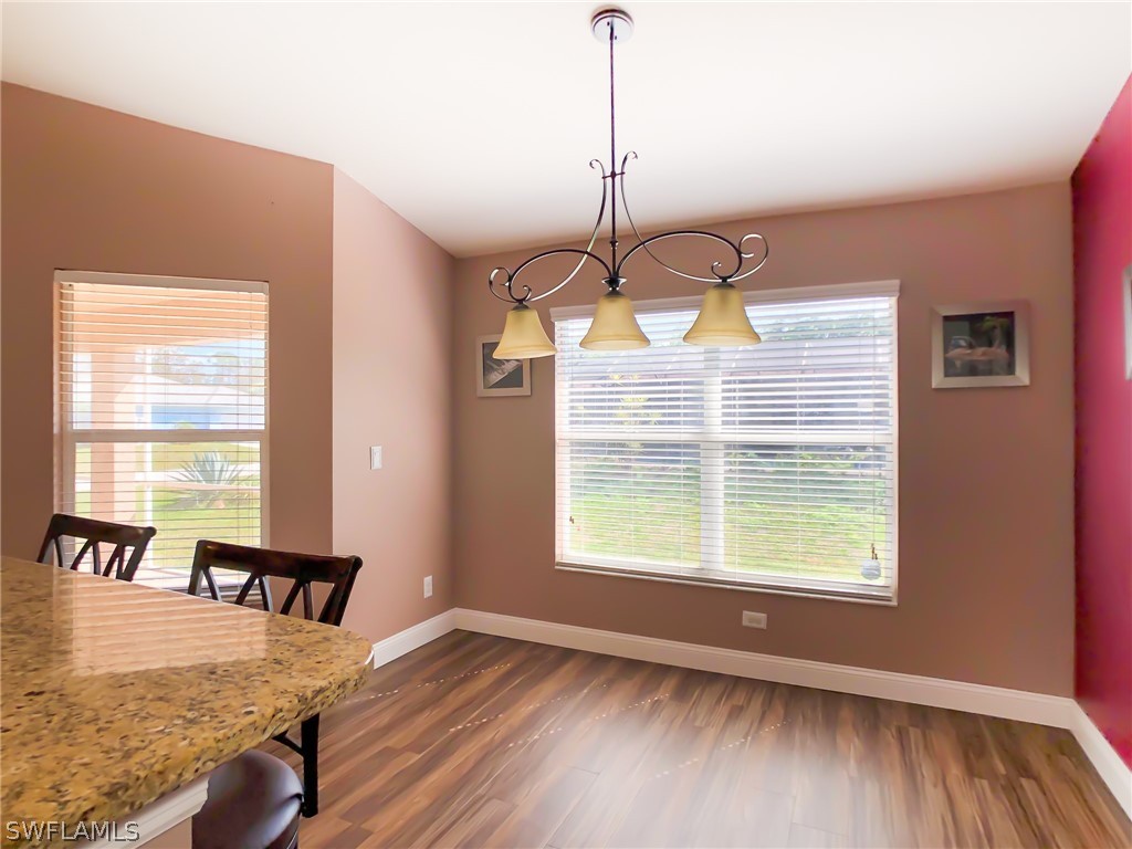 9068 Morris Road Fort Myers, FL 33967 - Photo 9 of 29 a view of a room with wooden floor windows and outdoor view