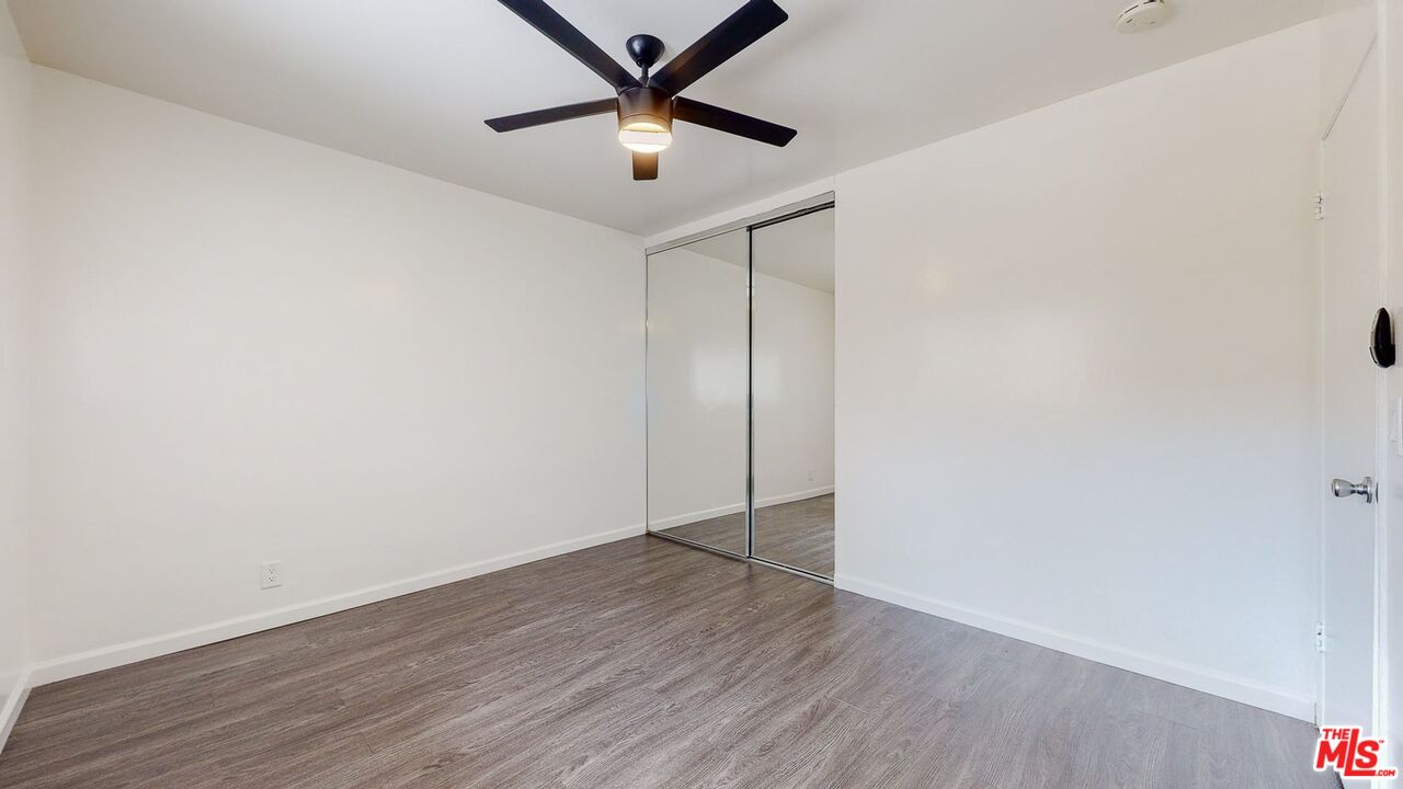 40 South Meridith Avenue, Unit 2 Pasadena, CA 91106 - Photo 11 of 14 an empty room with wooden floor and a ceiling fan