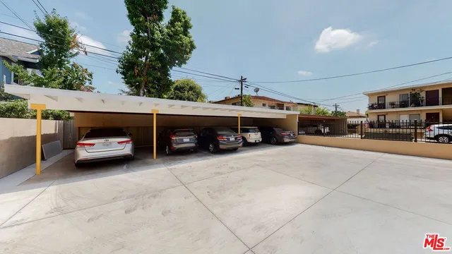 a couple of cars parked in parking area of a building