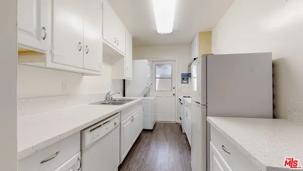 a kitchen with a sink and a refrigerator