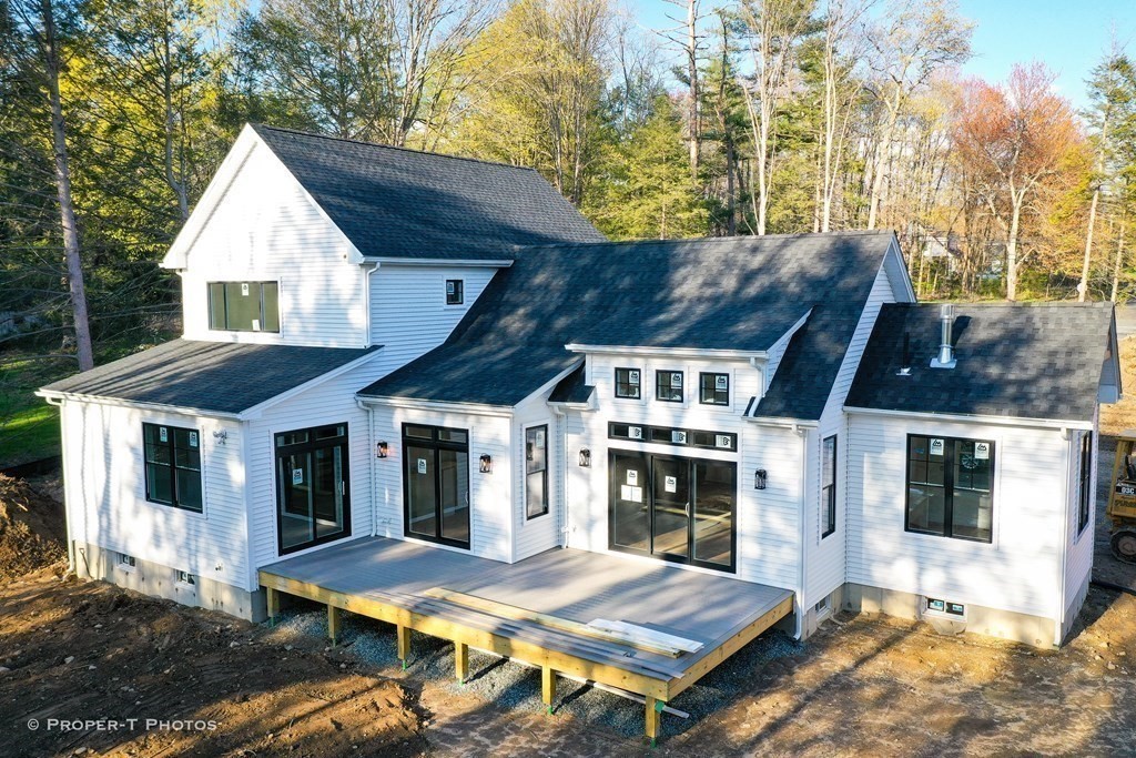 a view of house with backyard space and balcony