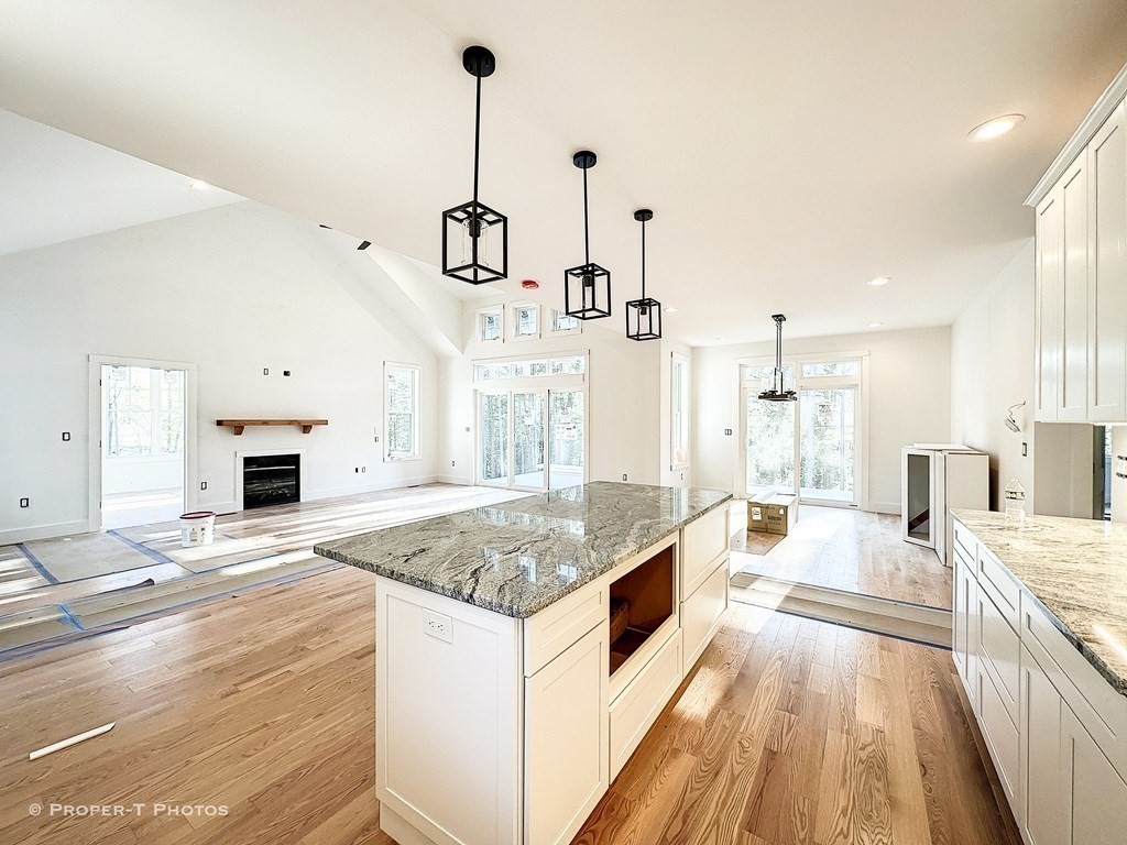 101 Glendale Road Hampden, MA 01036 - Photo 10 of 39 a large kitchen with kitchen island a stove a center island and living room view