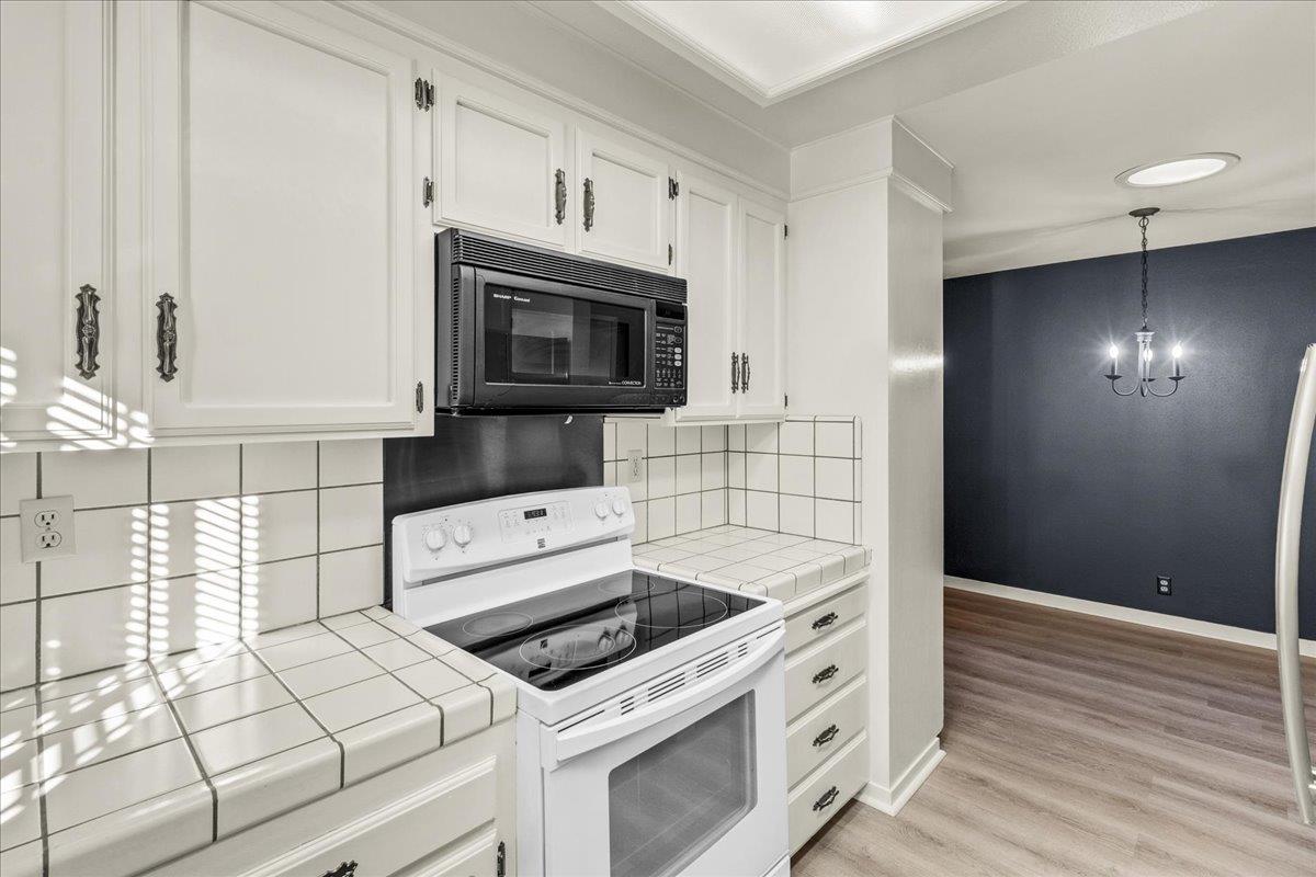 118 Nissen Road, Unit 1 Salinas, CA 93901 - Photo 11 of 39 a kitchen with granite countertop white cabinets and white appliances