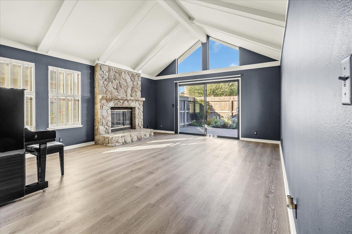 118 Nissen Road, Unit 1 Salinas, CA 93901 - Photo 7 of 39 an empty room with windows wooden floor and a fireplace