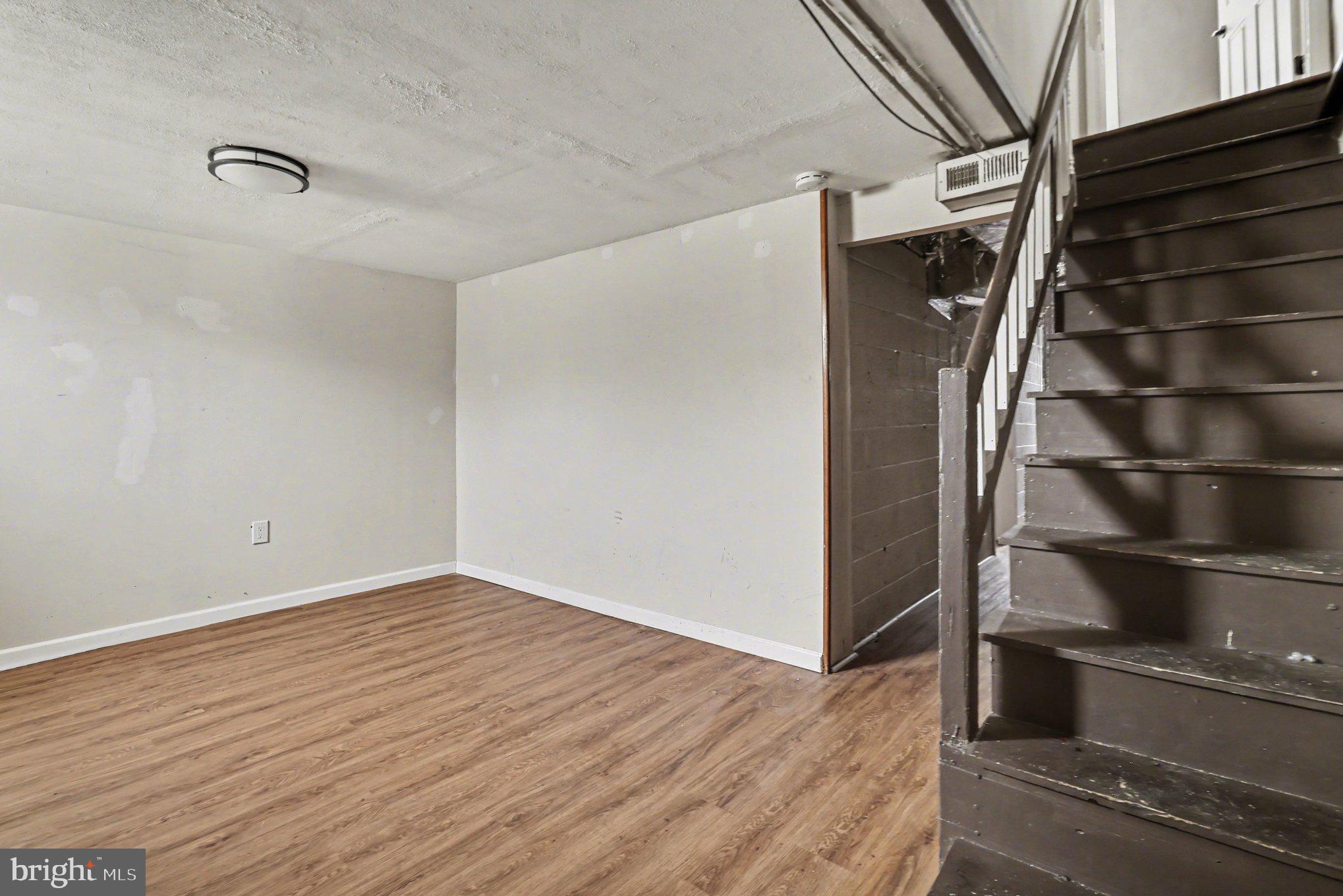 798 Bennington Road Folcroft, PA 19032 - Photo 21 of 28 a view of an empty room with wooden floor and windows