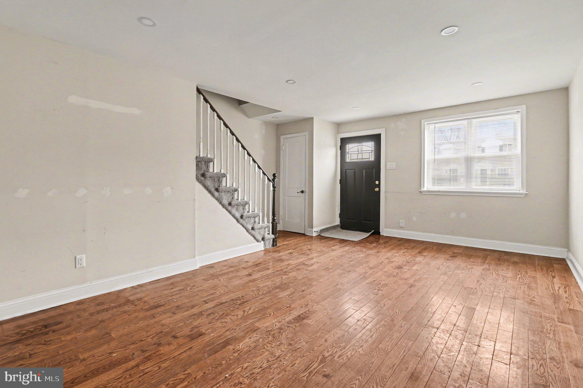 798 Bennington Road Folcroft, PA 19032 - Photo 3 of 28 a view of an empty room with wooden floor and stairs