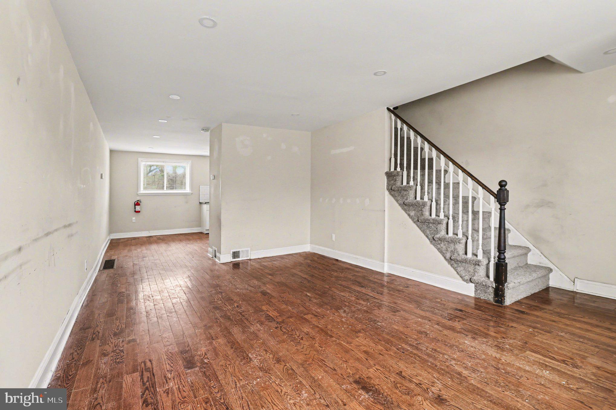 798 Bennington Road Folcroft, PA 19032 - Photo 5 of 28 a view of an empty room with wooden floor and stairs