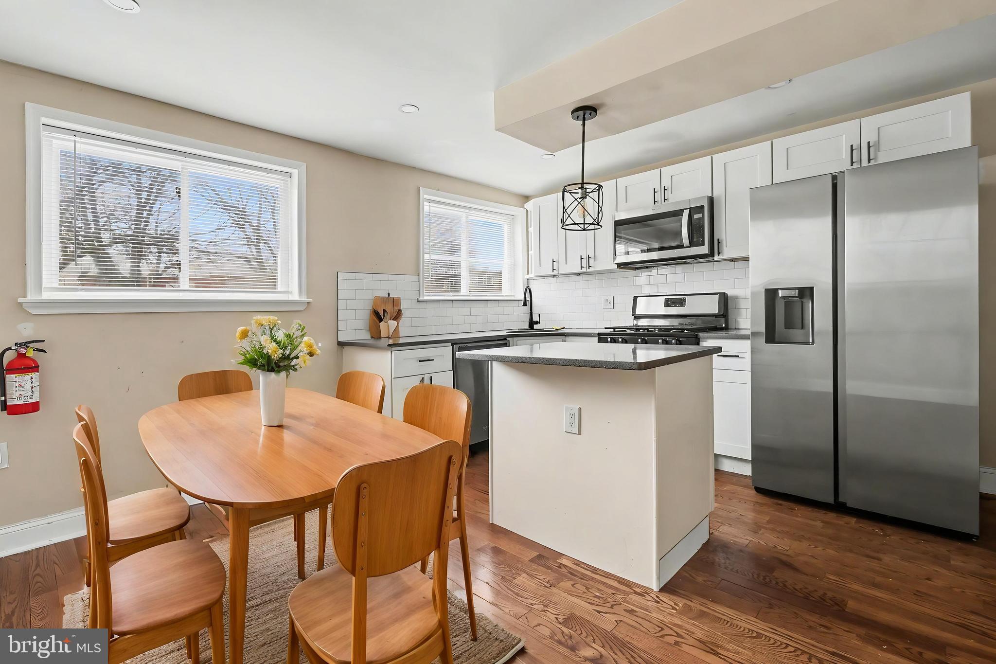 798 Bennington Road Folcroft, PA 19032 - Photo 6 of 28 a kitchen with stainless steel appliances granite countertop a dining table chairs refrigerator and microwave