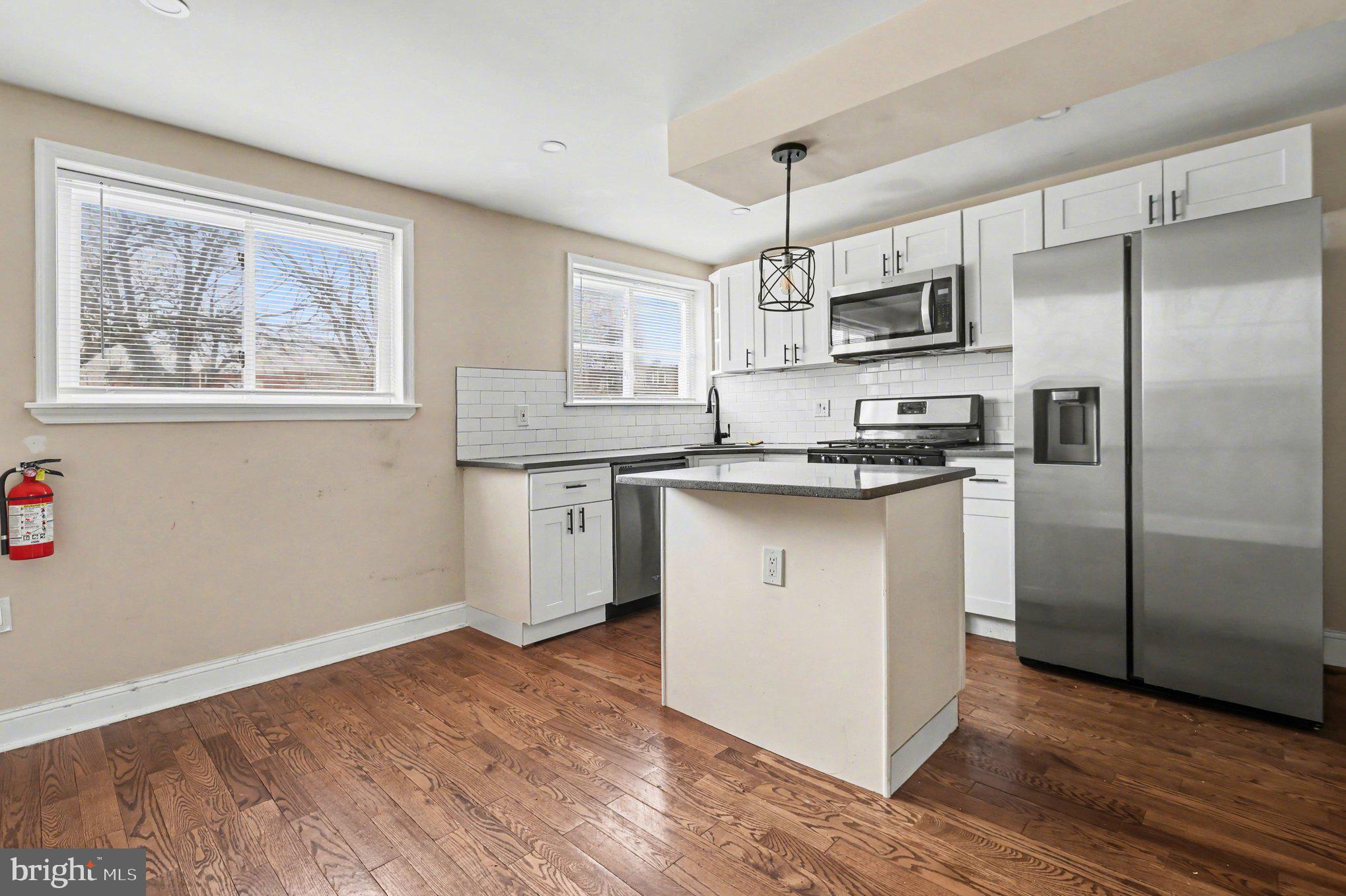 798 Bennington Road Folcroft, PA 19032 - Photo 7 of 28 a kitchen with stainless steel appliances granite countertop a refrigerator and a stove top oven