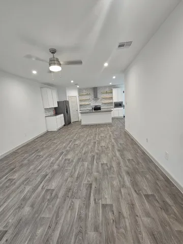 a view of a kitchen with kitchen island a counter top space and cabinets