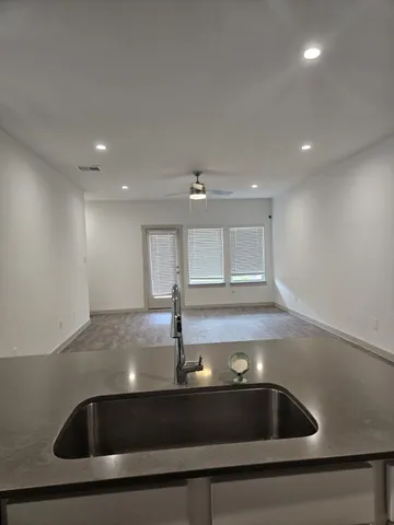 a kitchen with kitchen island a sink stainless steel appliances and window