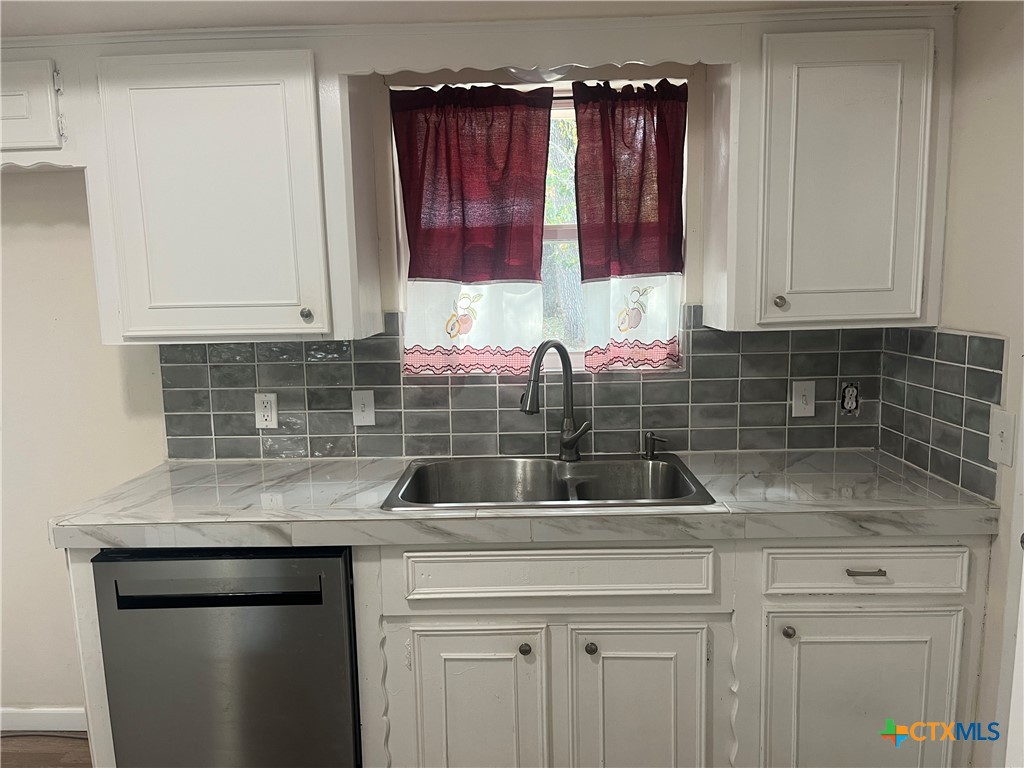 2603 West Main Street Cameron, TX 76520 - Photo 11 of 26 a kitchen with a sink and cabinets