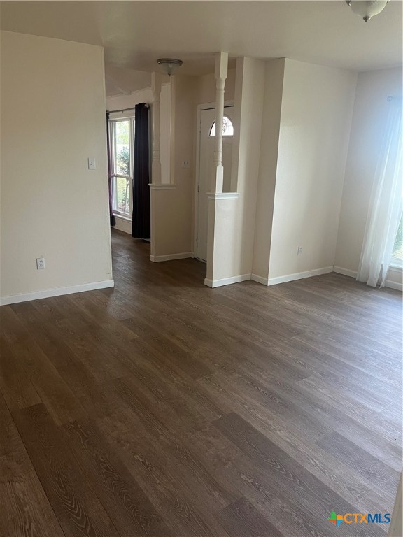 2603 West Main Street Cameron, TX 76520 - Photo 14 of 26 an empty room with wooden floor and mirror