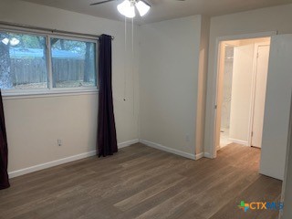2603 West Main Street Cameron, TX 76520 - Photo 19 of 26 an empty room with wooden floor and windows