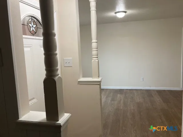 a view of a livingroom with a fireplace a chandelier and stairs
