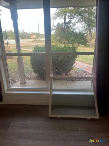 a bathroom with a bathtub and next to a window
