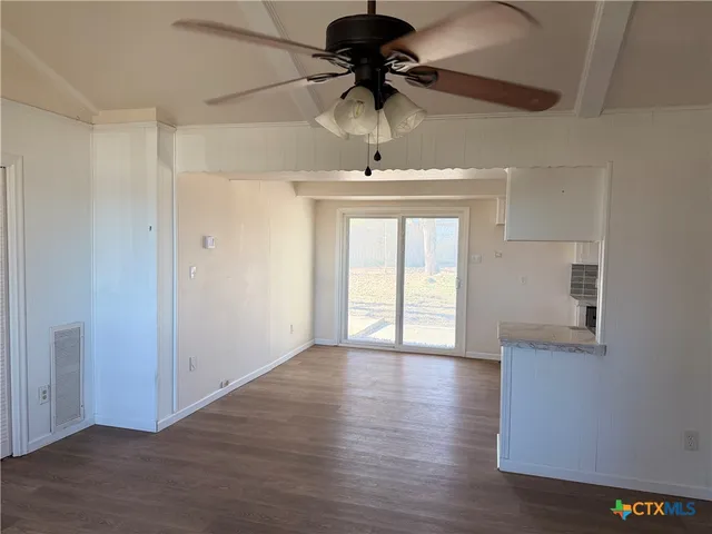 a kitchen with a stove and white cabinets