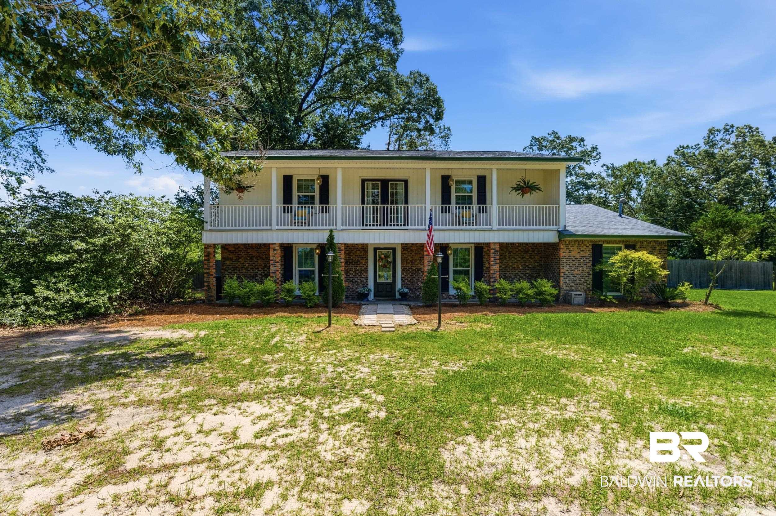 51620 Robert White Road Bay Minette, AL 36507 - Photo 3 of 81 Two-story property featuring a brick lower level and an upper-level balcony with white railings