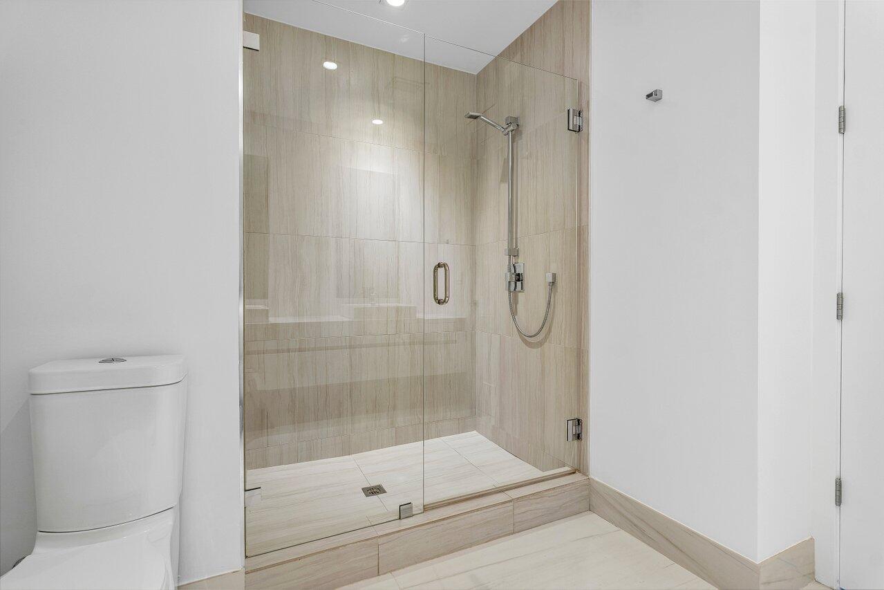 155 East Boca Raton Road, Unit 919 Boca Raton, FL 33432 - Photo 14 of 45 a bathroom with a shower a toilet and sink