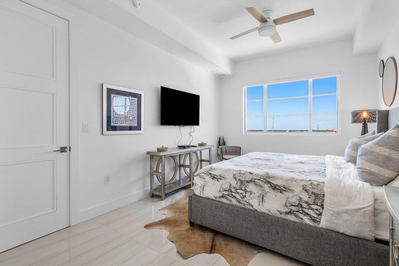 155 East Boca Raton Road, Unit 919 Boca Raton, FL 33432 - Photo 16 of 45 a bedroom with a bed and a flat screen tv