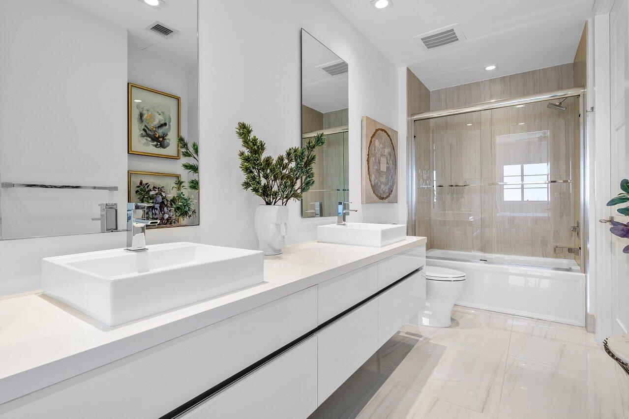 155 East Boca Raton Road, Unit 919 Boca Raton, FL 33432 - Photo 17 of 45 a bathroom with a bathtub double sink and mirror